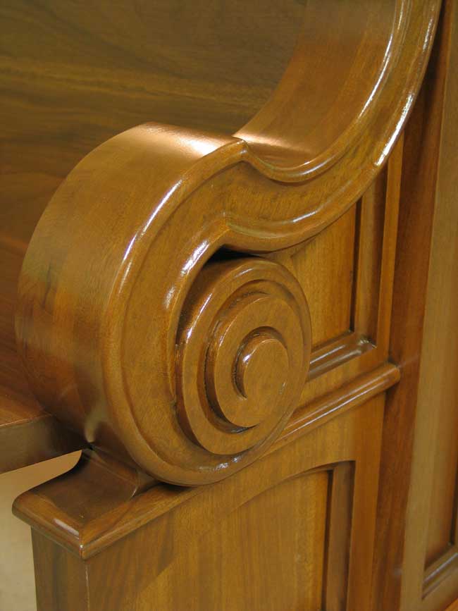 Arm detail of custom mahogany pew end.