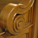 Arm detail of custom mahogany pew end.
